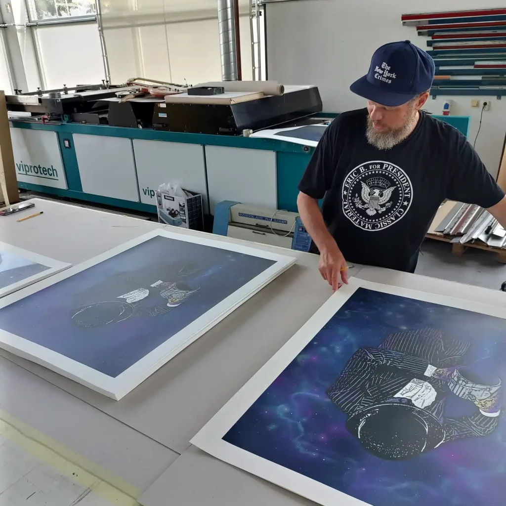 Nick Walker holds his limited edition print Time and Space