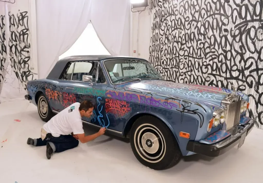 JonOne paints a Rolls Roys car in his unique graffiti style